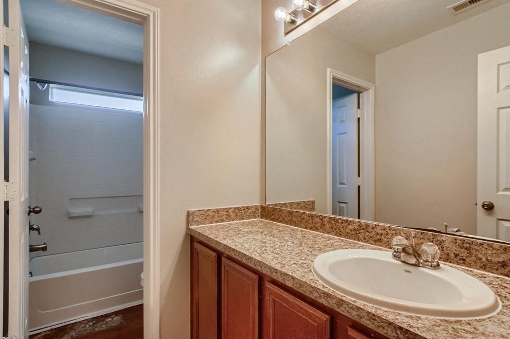 a bathroom with a sink and a mirror and a shower