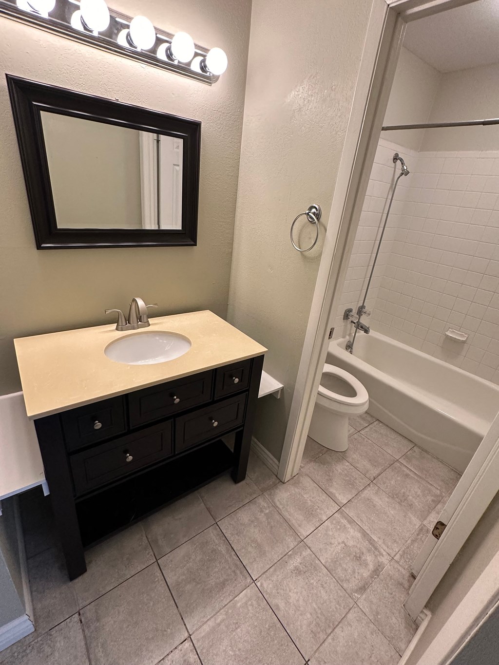 a bathroom with a sink and a shower and a toilet