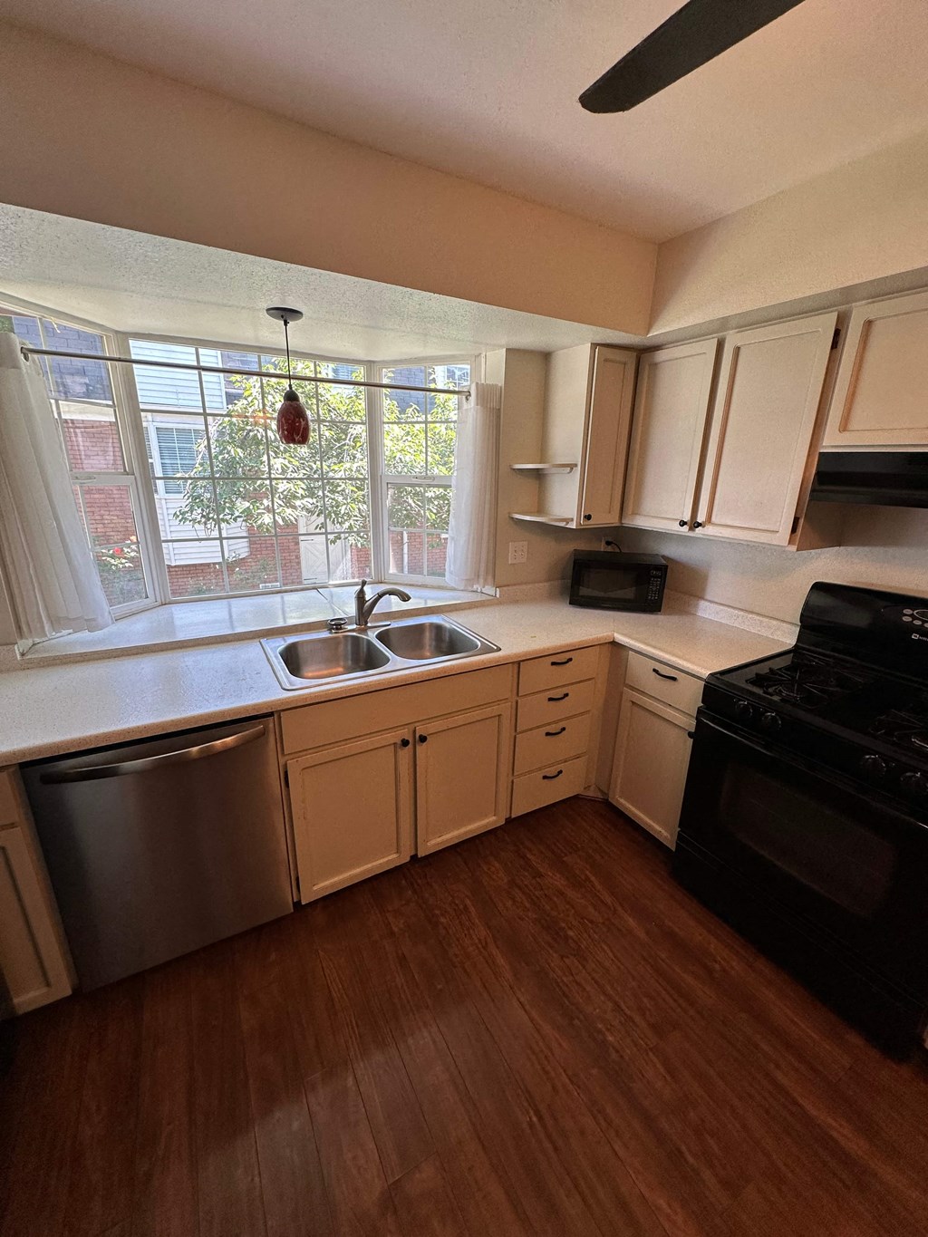 an empty kitchen with a sink and a window
