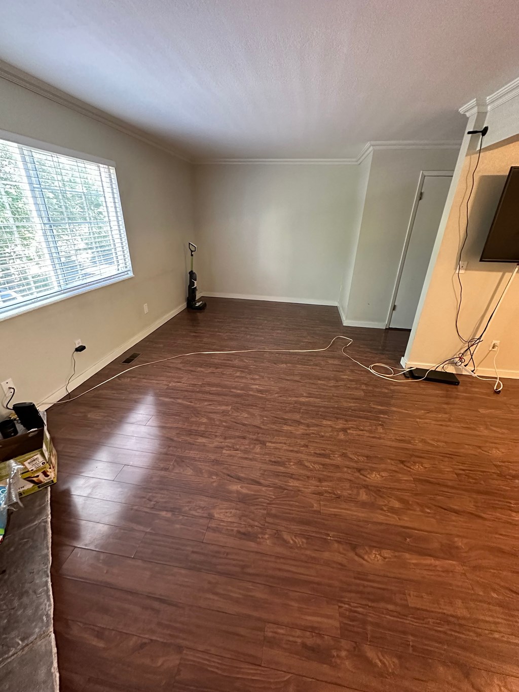 a living room with a hard wood floor and a tv