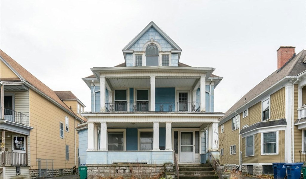 a blue and white house with a porch