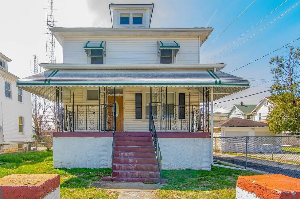 an old house with a porch and a staircase