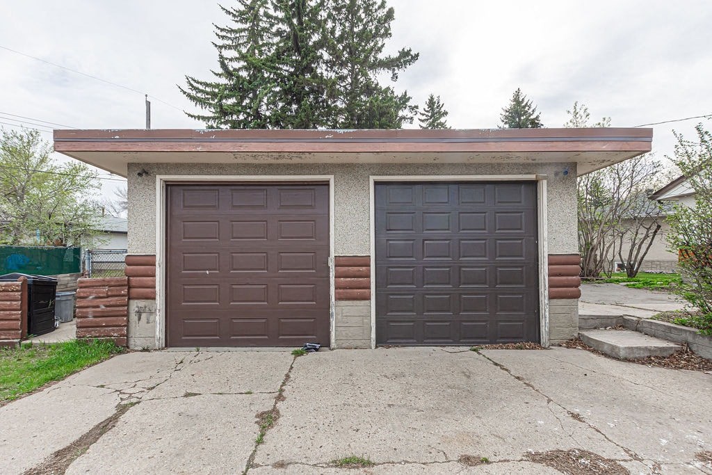 a house with two garage doors and a driveway