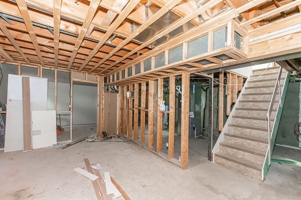 a house under construction with a staircase and wood framing