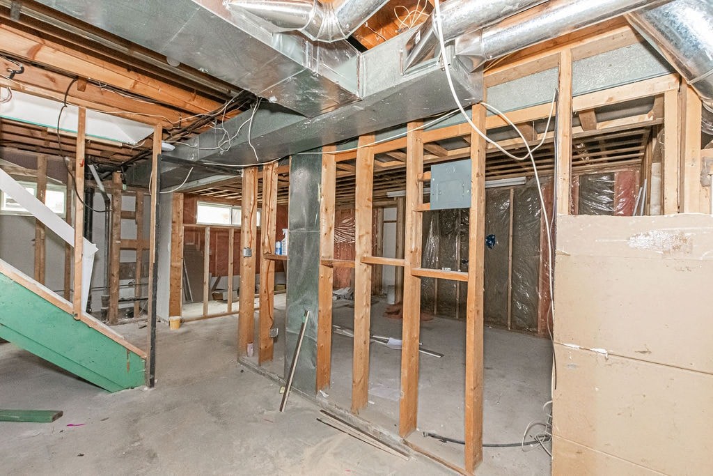 a house under construction with wood studs and a staircase