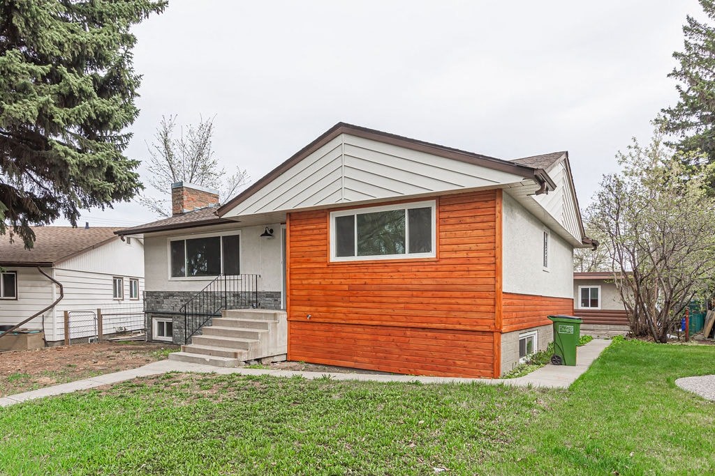 a small house with a wooden front porch and stairs