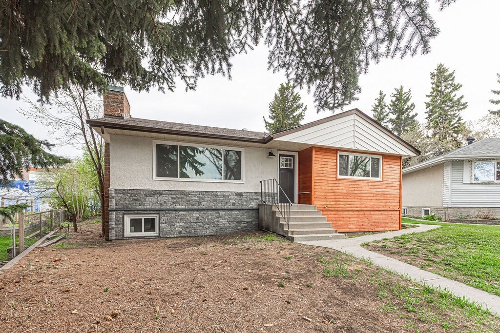 the front of a house with a yard and stairs