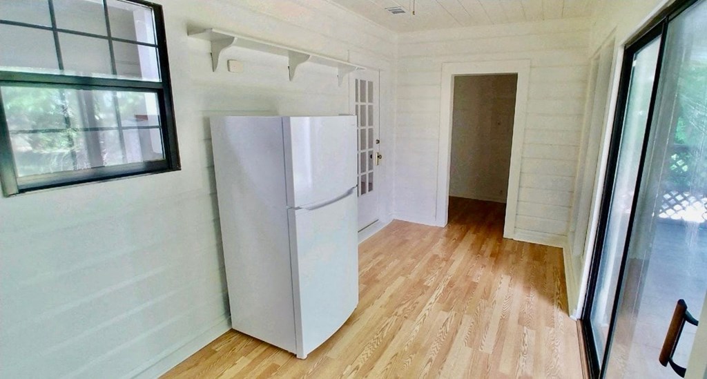 a small room with a white refrigerator in it