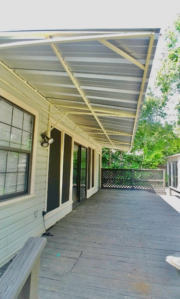 a porch with a metal roof on a house