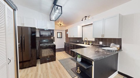 a kitchen with a large counter top and a refrigerator
