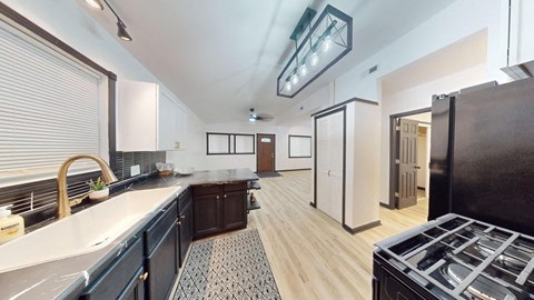a kitchen with a counter top and a stove and a refrigerator