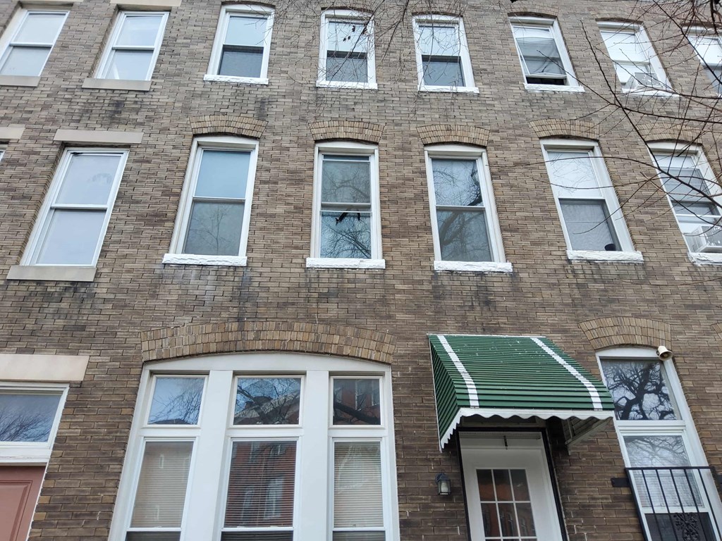 a brick building with a green and white awning