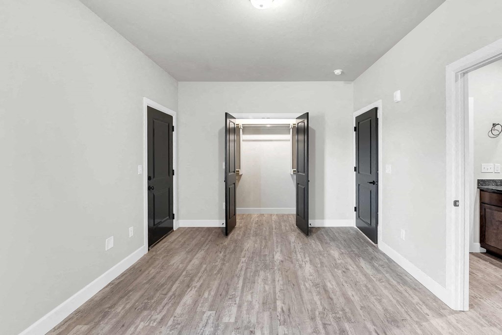 a renovated living room with white walls and wood floors