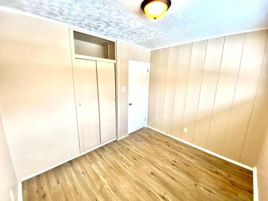 a empty room with white cabinets and a light on the ceiling