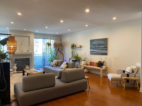 a living room with couches and chairs and a fireplace