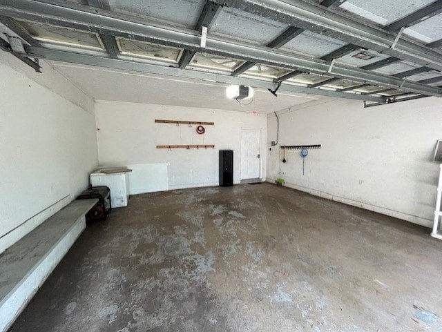 the inside of a garage with a concrete floor and white walls
