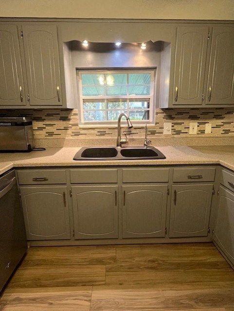 a kitchen with white cabinets and a sink and a window