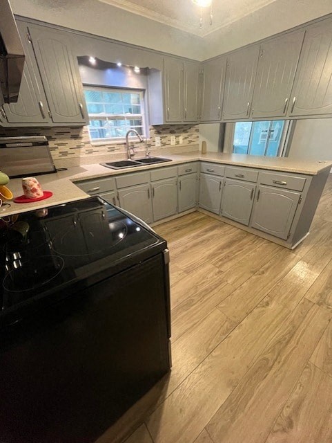a kitchen with white cabinets and a black dishwasher