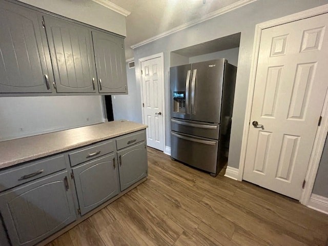 a kitchen with a stainless steel refrigerator and white cabinets