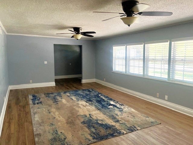 an empty living room with a ceiling fan and rugs