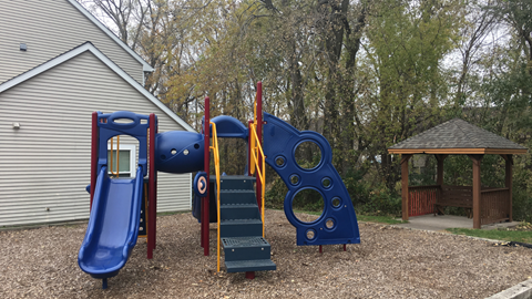 a playground with a swing set and other playground equipment