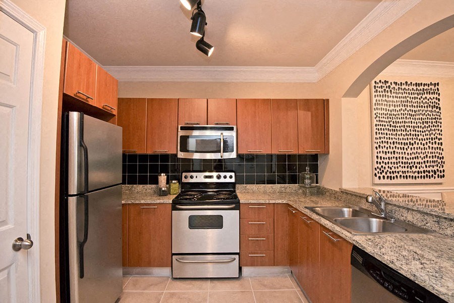 a kitchen with a stove refrigerator and a sink