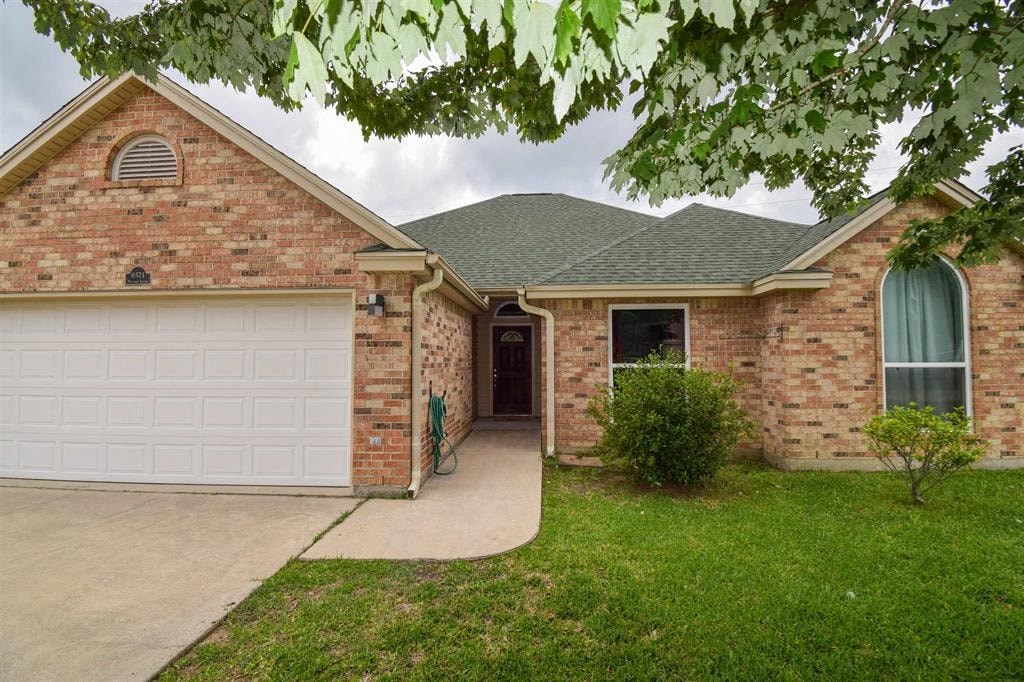 a brick house with a white garage door