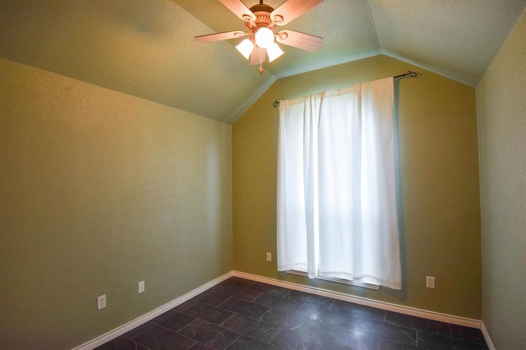a living room with a ceiling fan and a window