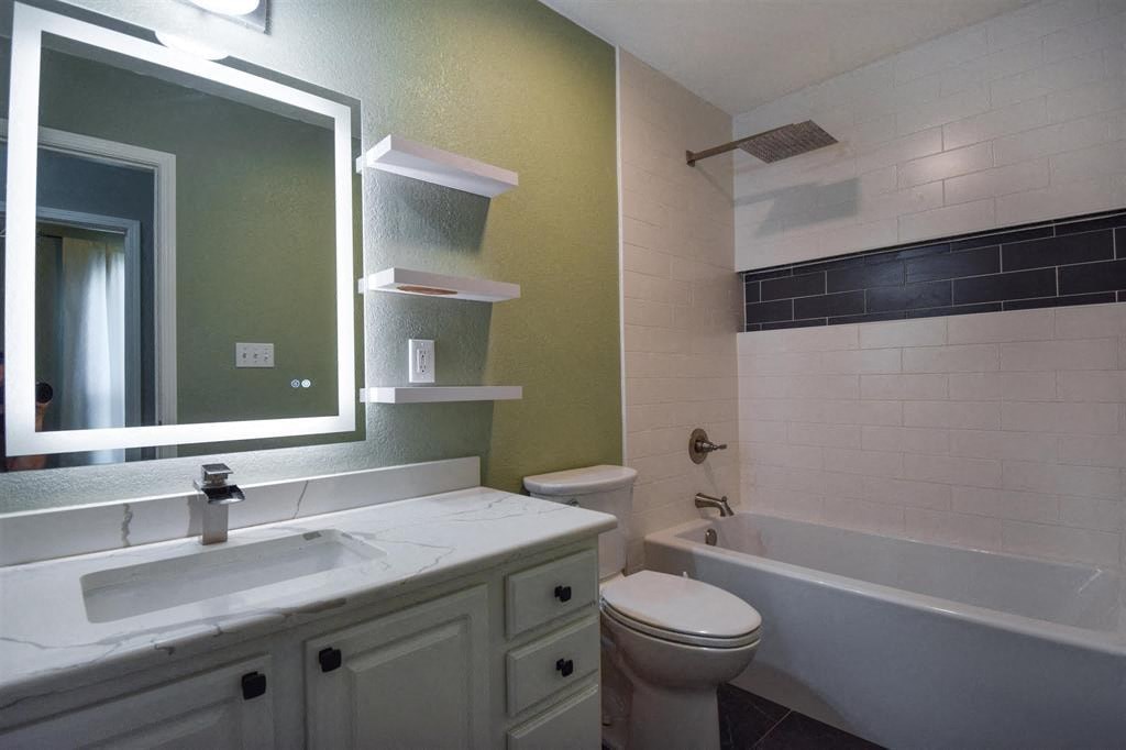 a bathroom with a sink toilet and a mirror