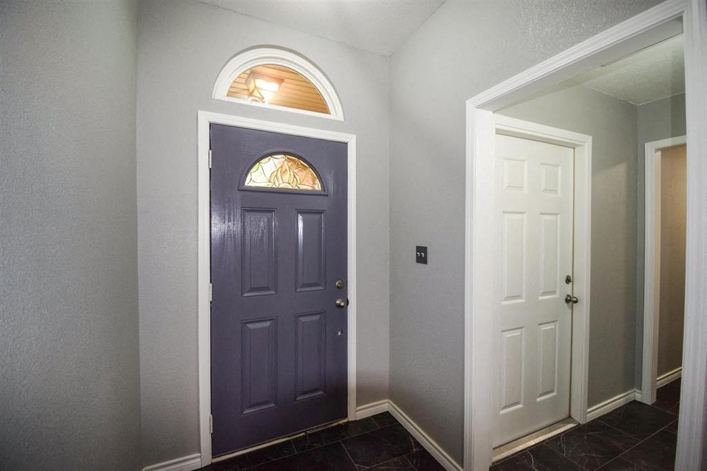 a blue door in a room with a white door