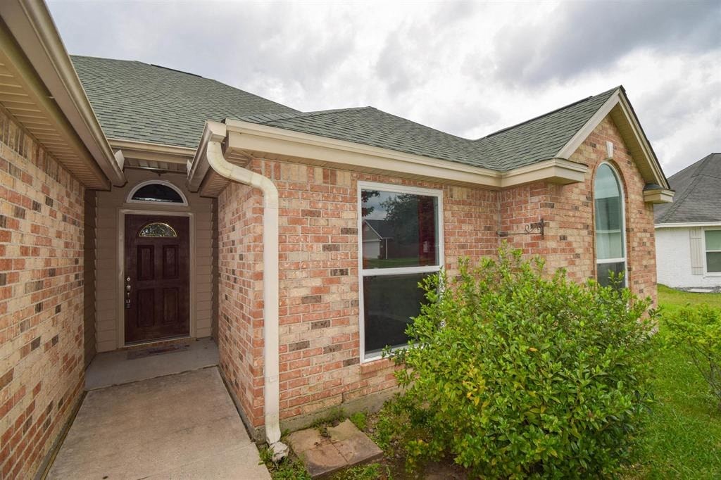 the front of a brick house with a front door