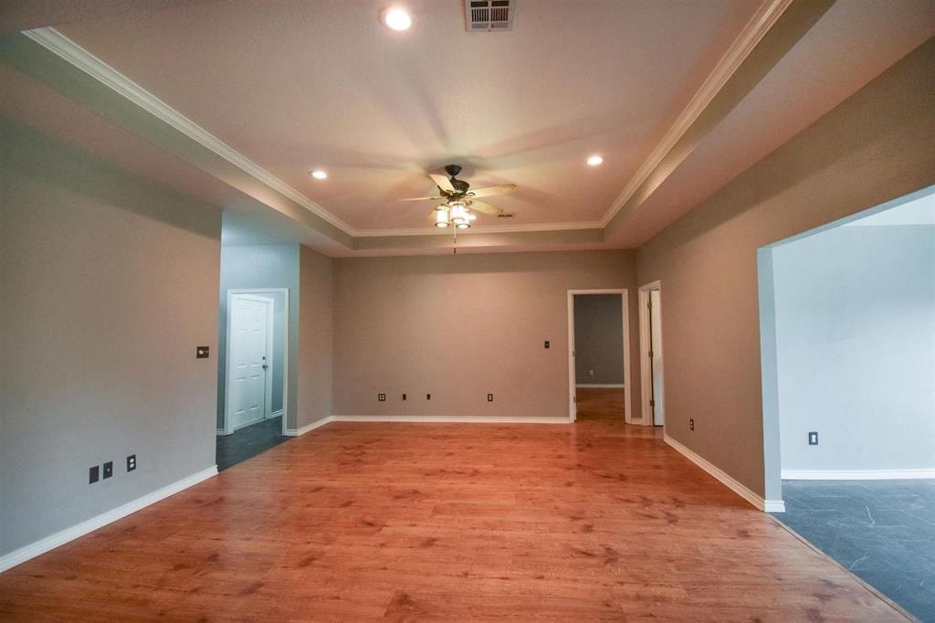 a empty living room with a ceiling fan