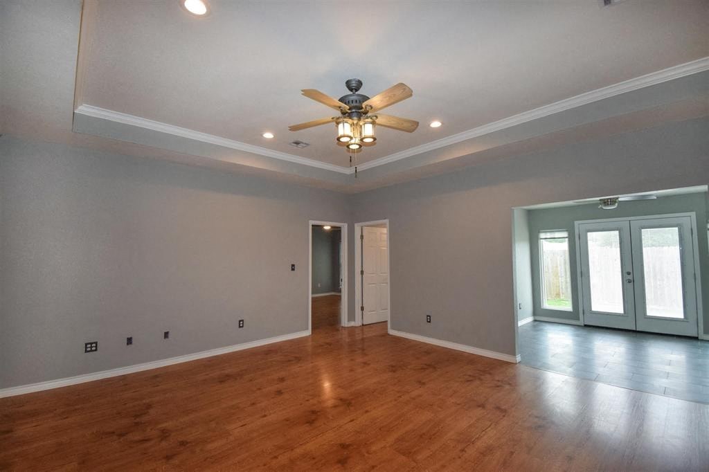an empty living room with a ceiling fan