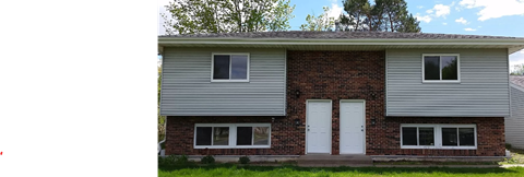 a white and brick house with white doors and windows