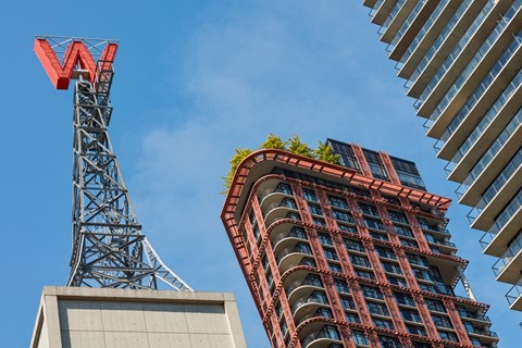 a tower crane next to a tall building