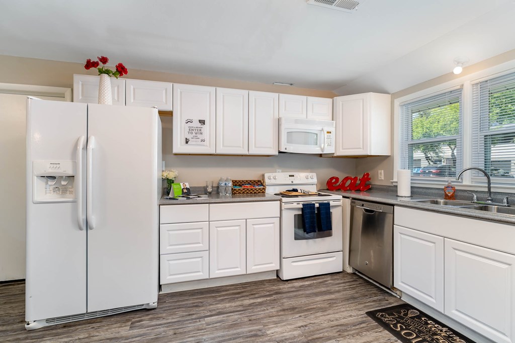 a kitchen with white cabinets and stainless steel appliances
