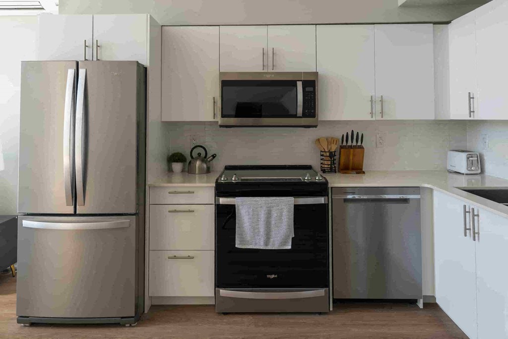 a kitchen with stainless steel appliances and white cabinets