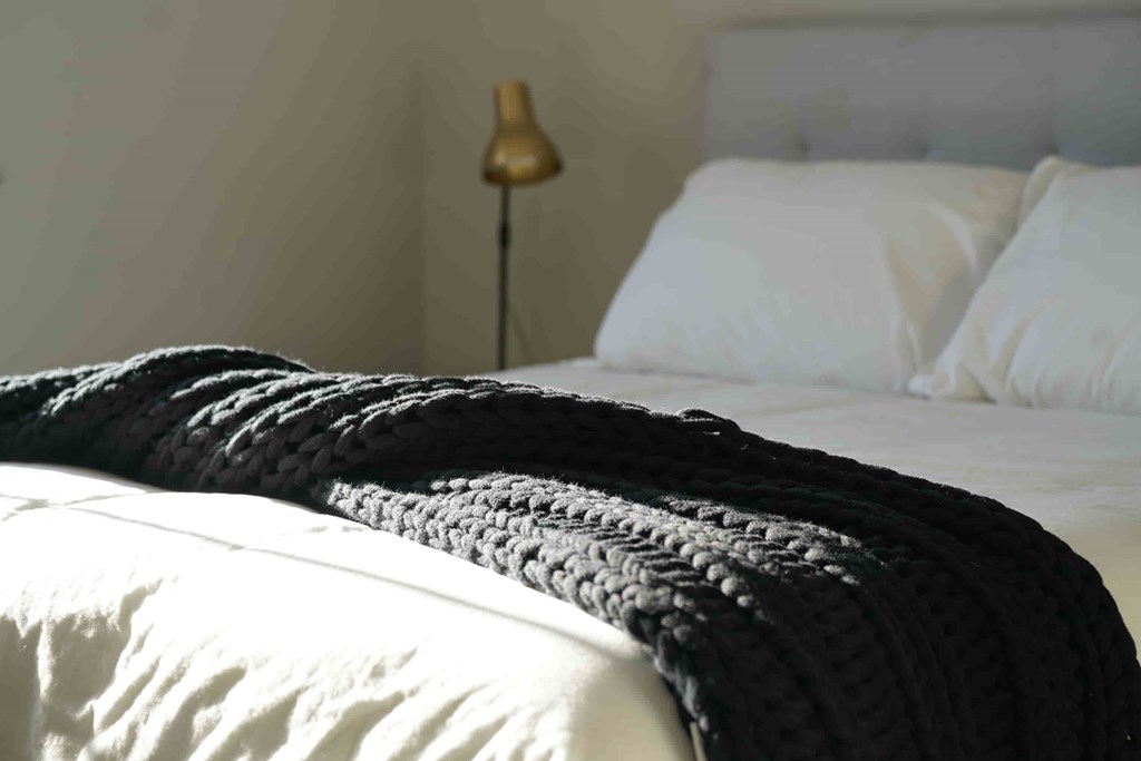 a bed with a blanket on top of it