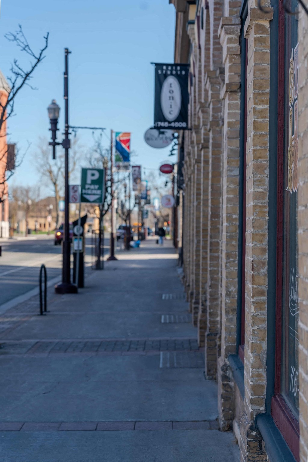 a city street with a clock on the side of a building