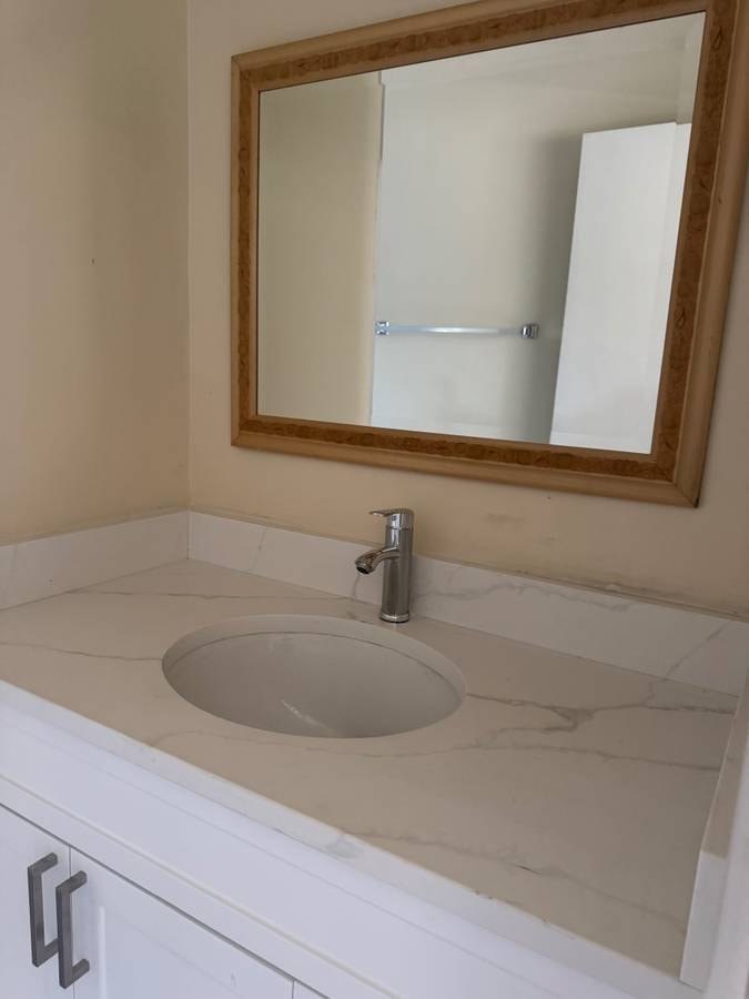 A bathroom sink with a mirror above it.