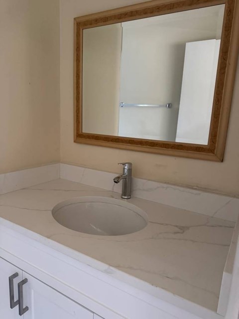 A bathroom sink with a mirror above it.