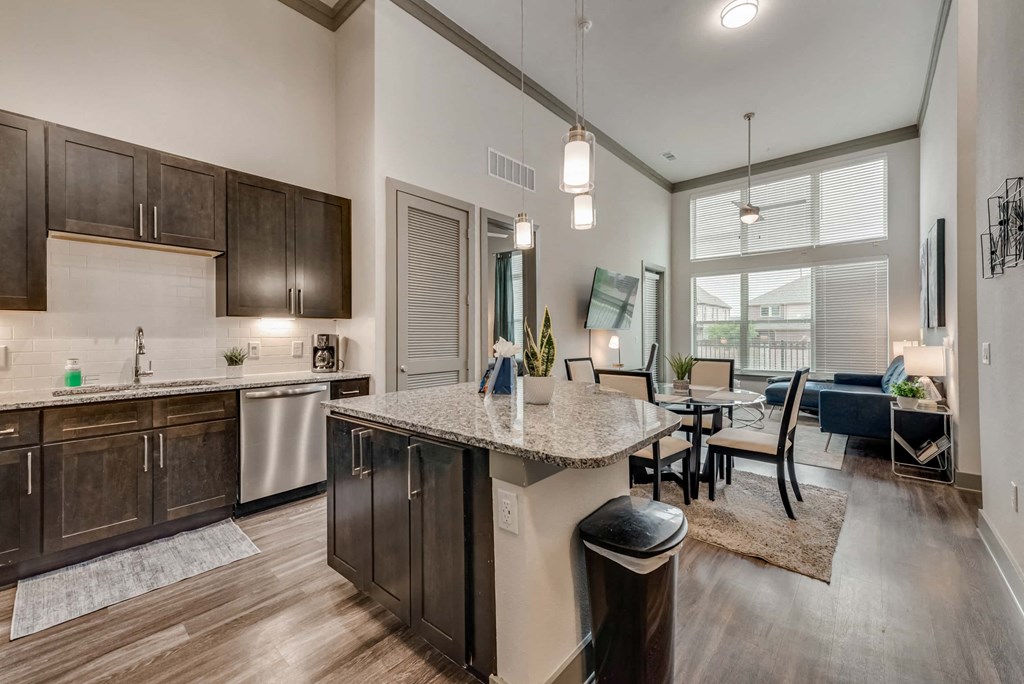an open kitchen and living room with a table and chairs