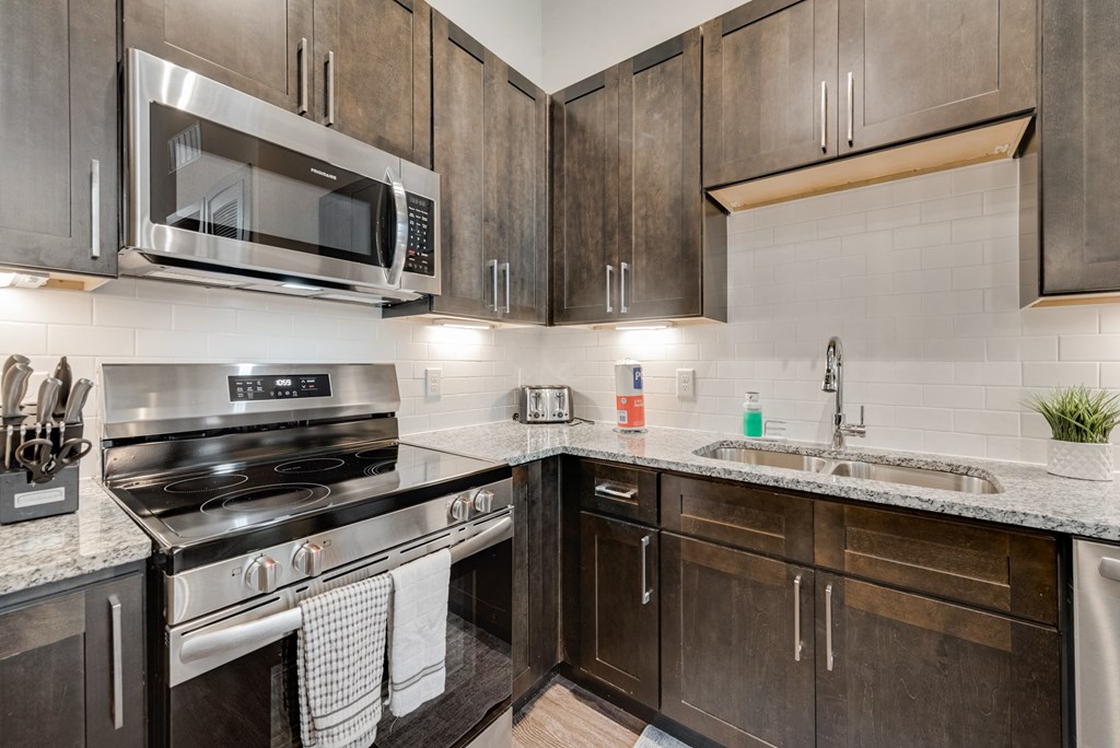 a kitchen with stainless steel appliances and wooden cabinets