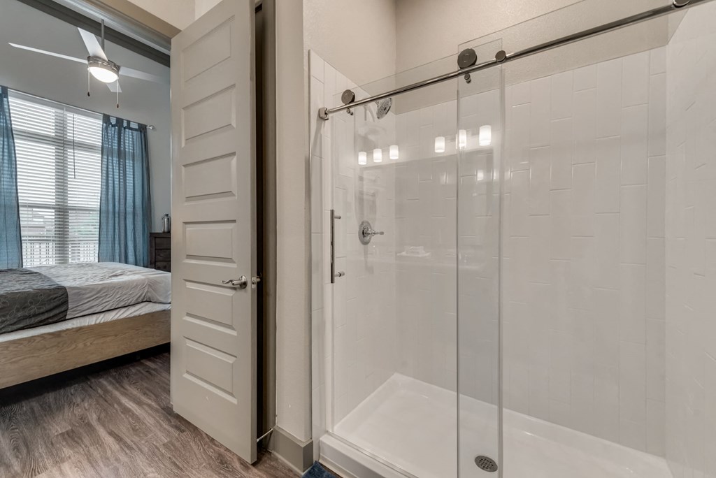 a bathroom with a shower and a bed