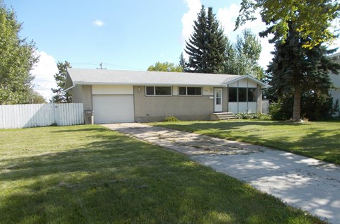 the front of a house with a sidewalk and grass