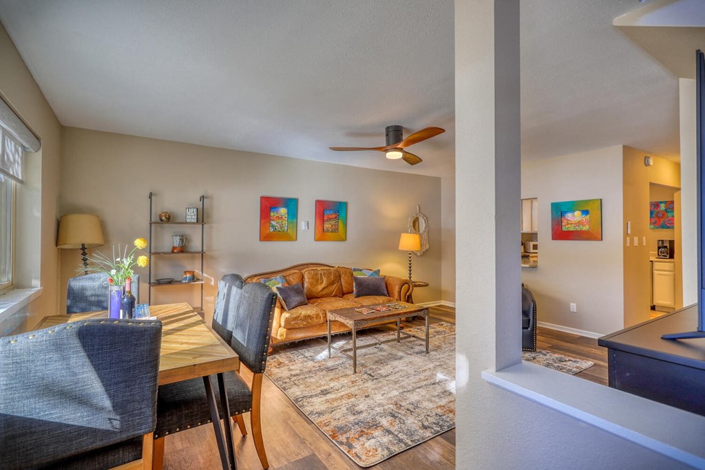 a living room with a couch and a ceiling fan