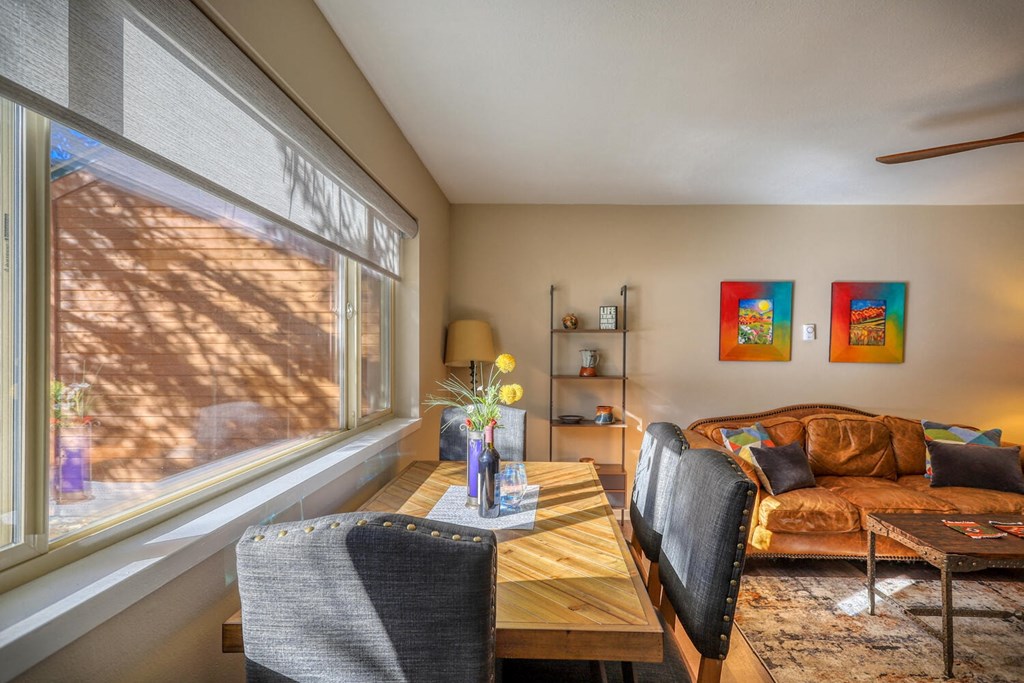 a living room with a couch and a table and a large window