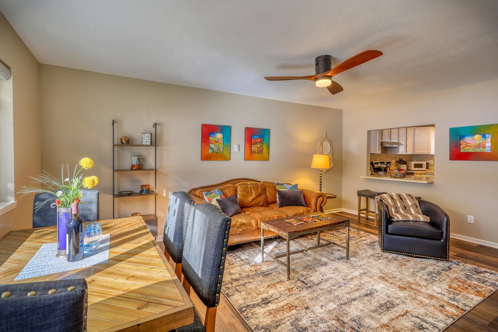 a living room with furniture and a ceiling fan