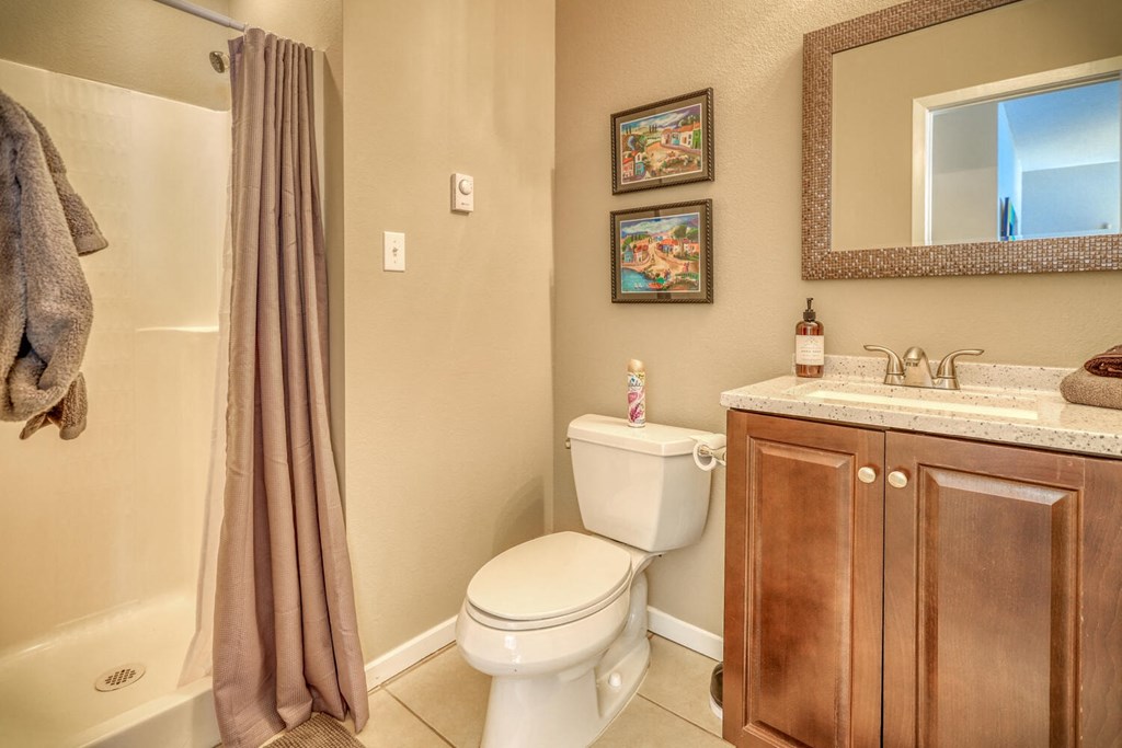 a bathroom with a toilet and a sink and a shower