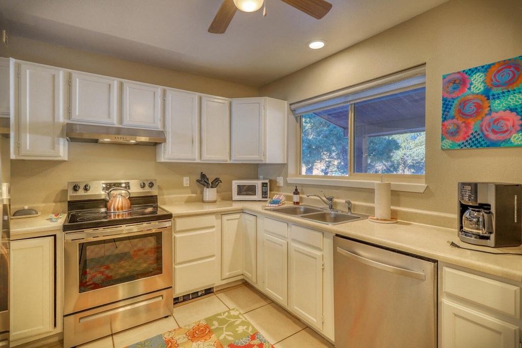 a kitchen with stainless steel appliances and white cabinets